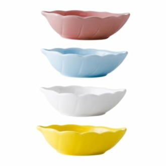 Four colorful scalloped bowls in pink, blue, white, and yellow.