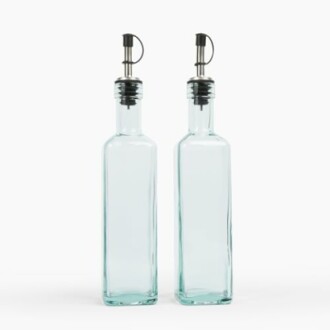 Two clear glass bottles with pour spouts