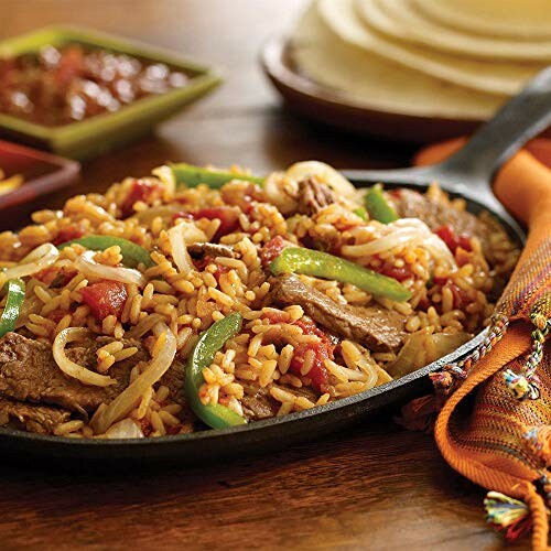 Sizzling beef and rice with vegetables in a skillet.